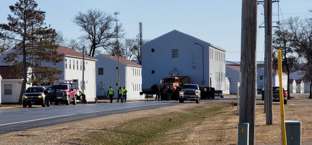 Continuing making history: Contractors move last two World War II-era barracks to new locations