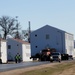 Continuing making history: Contractors move last two World War II-era barracks to new locations