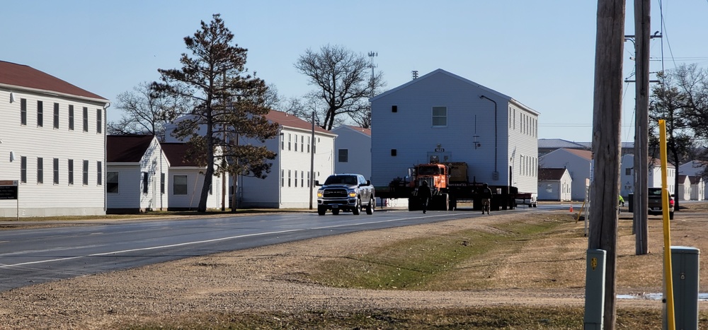 Continuing making history: Contractors move last two World War II-era barracks to new locations