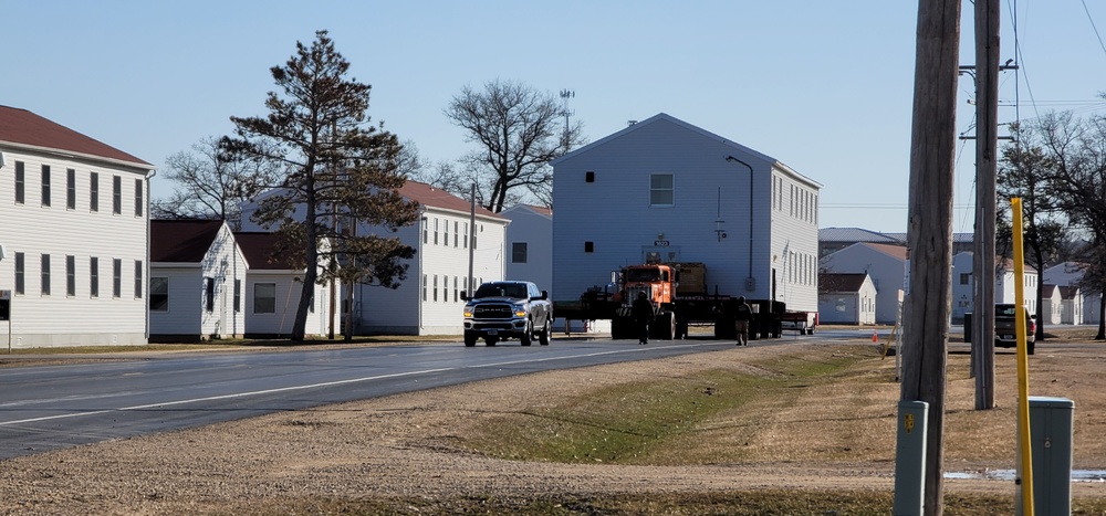 Continuing making history: Contractors move last two World War II-era barracks to new locations