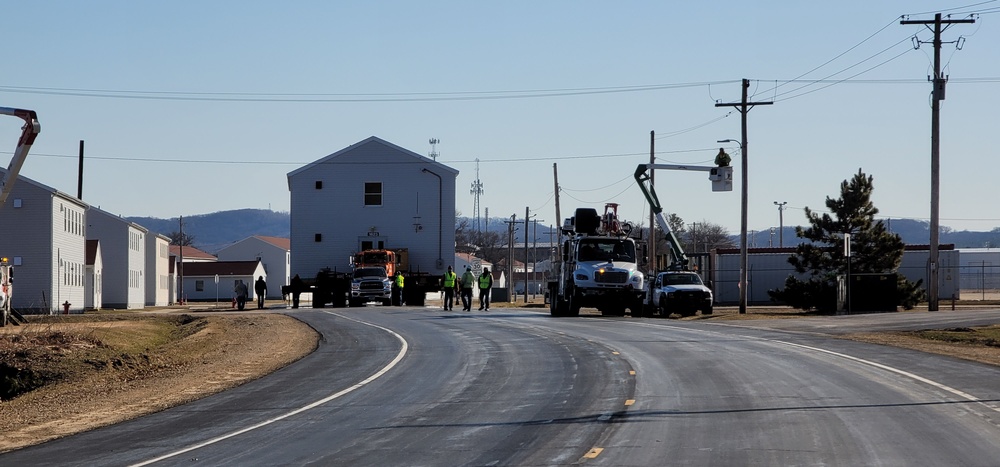 Continuing making history: Contractors move last two World War II-era barracks to new locations