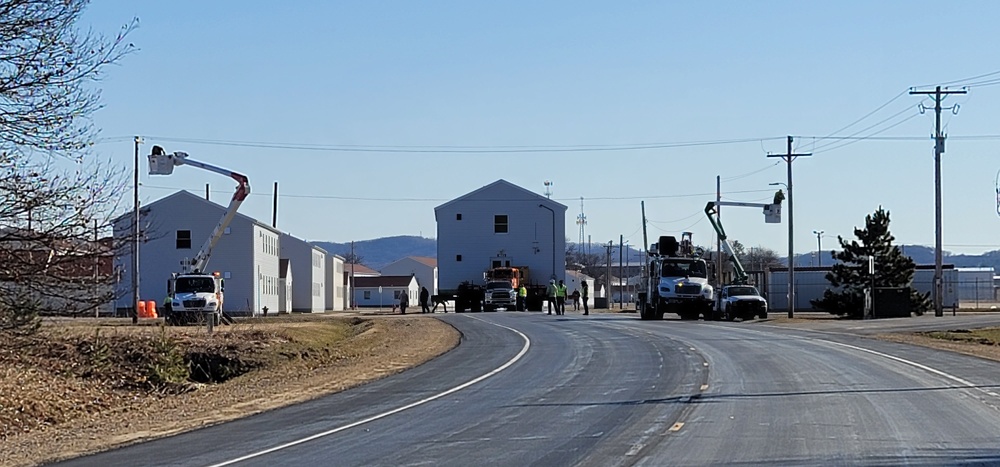 Continuing making history: Contractors move last two World War II-era barracks to new locations