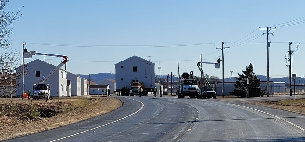 Continuing making history: Contractors move last two World War II-era barracks to new locations