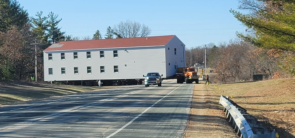 Continuing making history: Contractors move last two World War II-era barracks to new locations