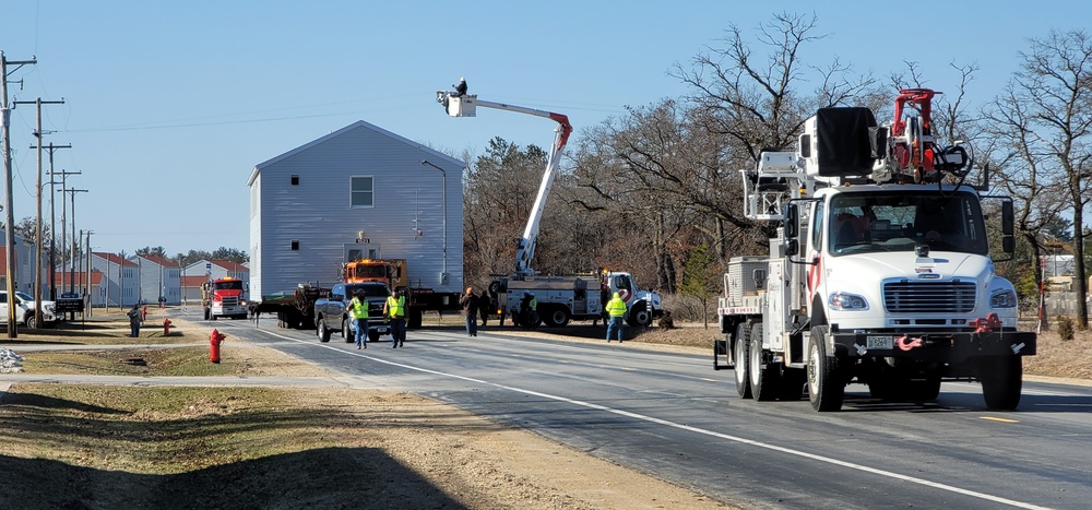 Continuing making history: Contractors move last two World War II-era barracks to new locations