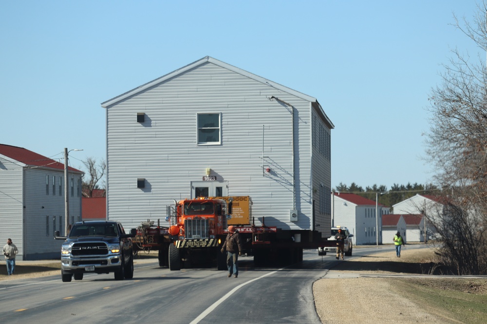 Continuing making history: Contractors move last two World War II-era barracks to new locations