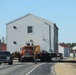 Continuing making history: Contractors move last two World War II-era barracks to new locations