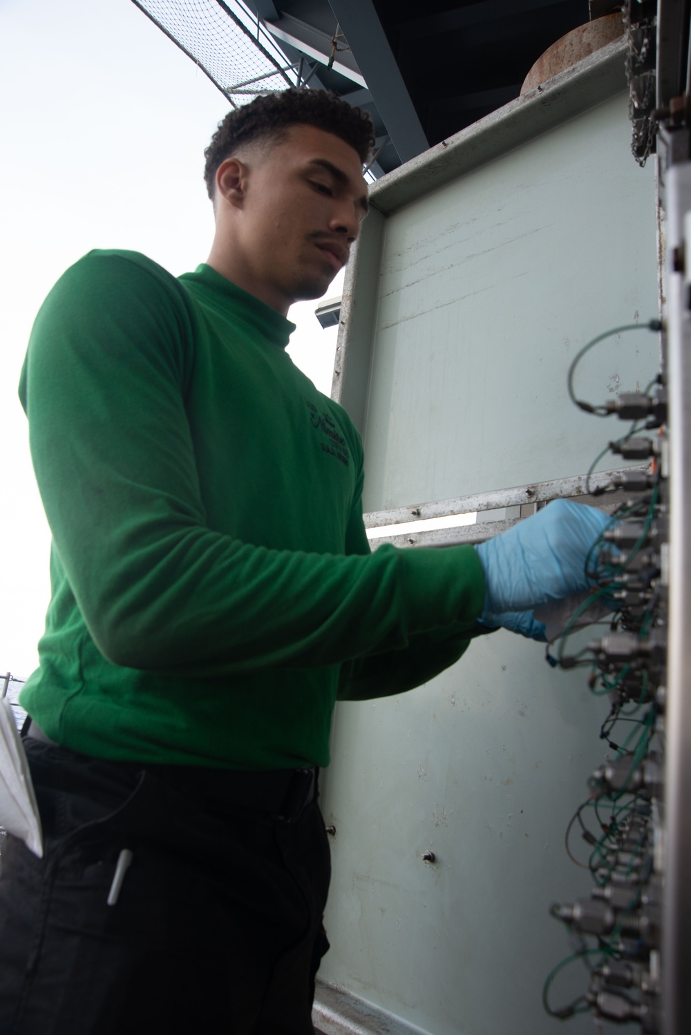 U.S. Navy Sailor Cleans An Engine Data Collection Board