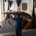 U.S. Navy Sailor Carries Boxes