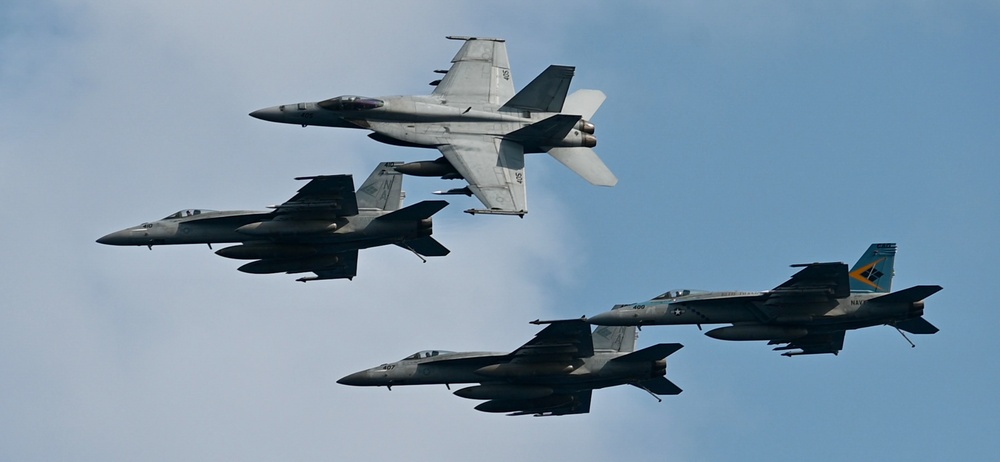 Four F/A-18E Super Hornets Fly In Formation Past USS Nimitz