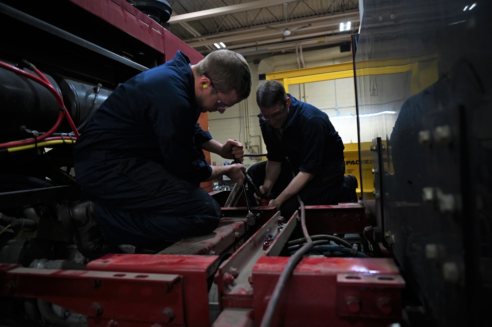 Vehicle Maintenance Removes A Fire Truck Engine