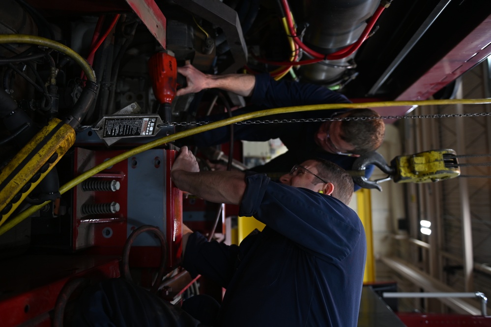 Vehicle Maintenance Removes A Fire Truck Engine