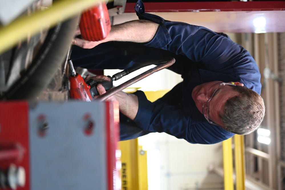 Vehicle Maintenance Removes A Fire Truck Engine