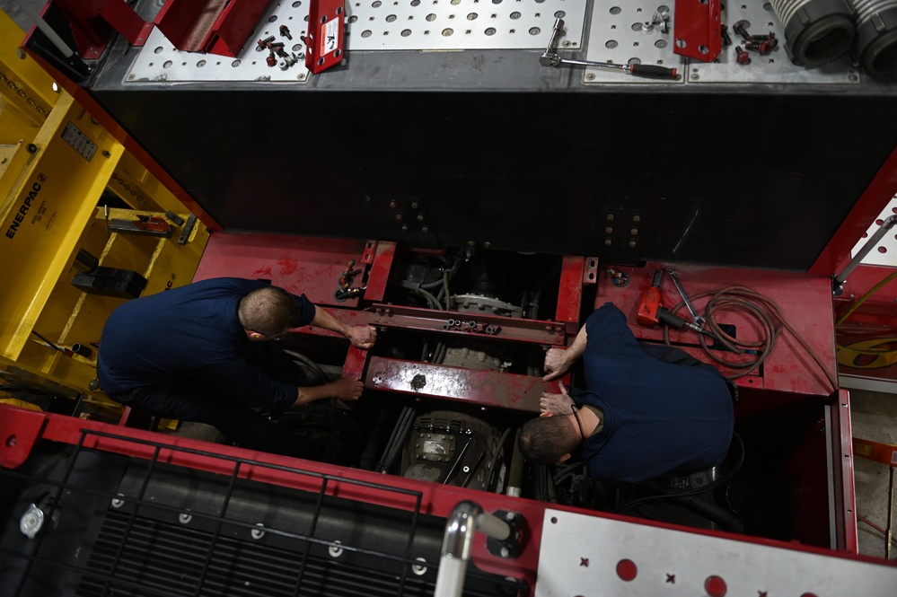 Vehicle Maintenance Removes A Fire Truck Engine