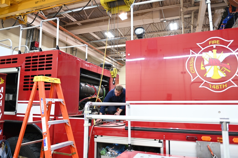 Vehicle Maintenance Removes A Fire Truck Engine