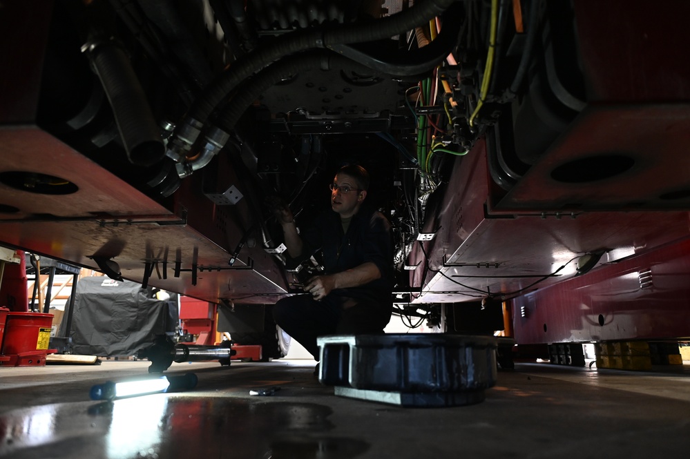 Vehicle Maintenance Removes A Fire Truck Engine