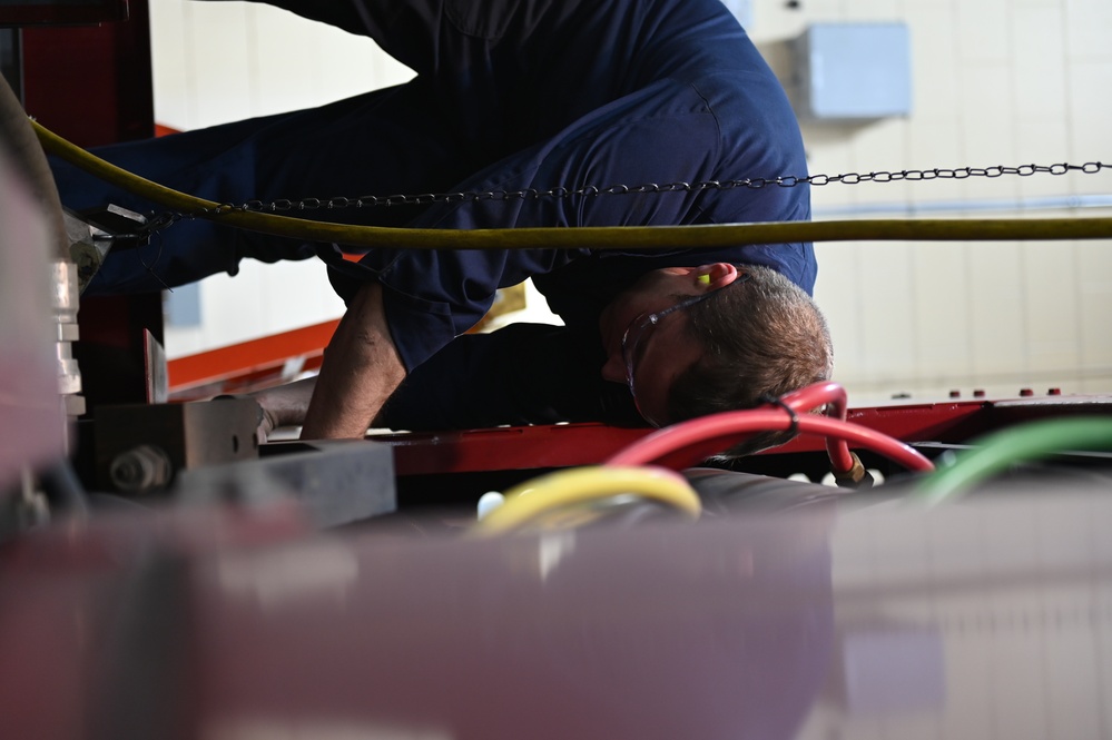 Vehicle Maintenance Removes A Fire Truck Engine