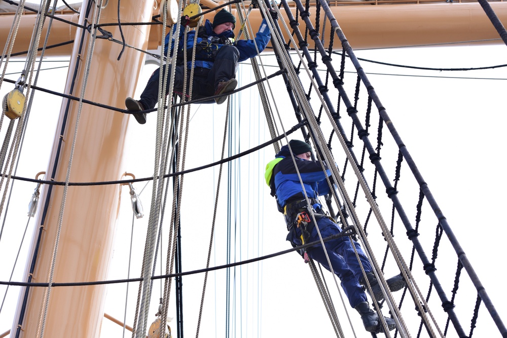 USCGC Eagle personnel conduct maintenance on training vessel’s rigging, sails