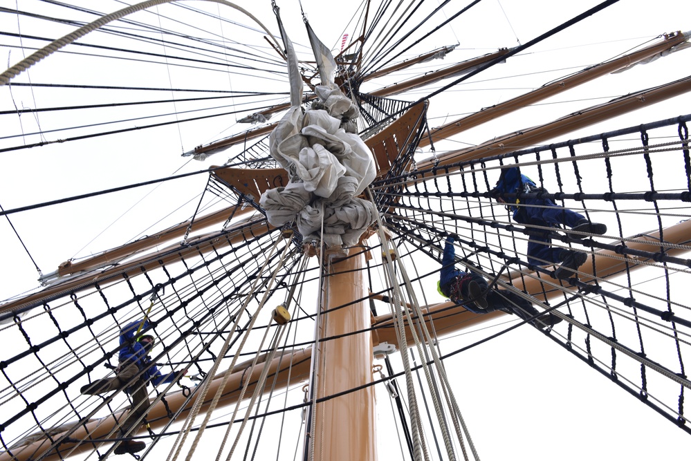 USCGC Eagle personnel conduct maintenance on training vessel’s rigging, sails