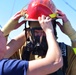 USCGC Eagle personnel don firefighting equipment during a drill while underway in the Atlantic Ocean