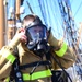 USCGC Eagle personnel don firefighting equipment during a drill while underway in the Atlantic Ocean