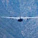 A C-130 from Wyoming Air National Guard's 153rd Airlift Wing flying thru a canyon during Modular Airborne Fire Fighting System (MAFFS) Spring Training 2023