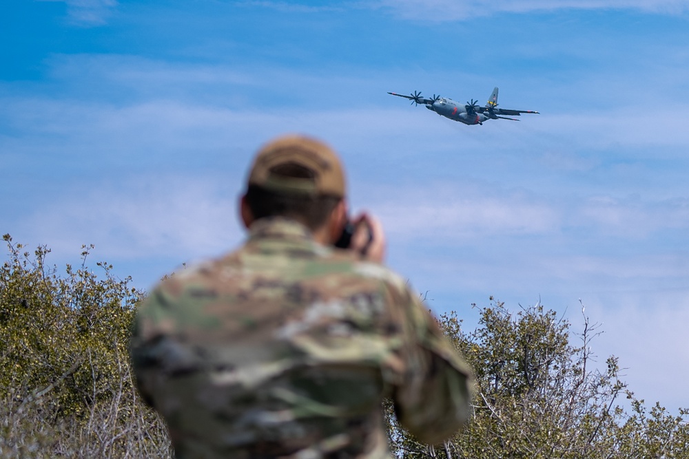 Public Affairs Specialist captures a C-130 flying during Modular Airborne Fire Fighting System (MAFFS) Training 2023