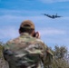 Public Affairs Specialist captures a C-130 flying during Modular Airborne Fire Fighting System (MAFFS) Training 2023