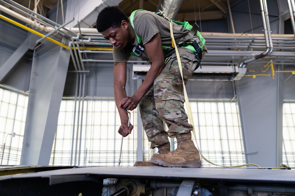 Airman works on the wing of a KC-135 during periodic inspection