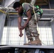 Airman works on the wing of a KC-135 during periodic inspection