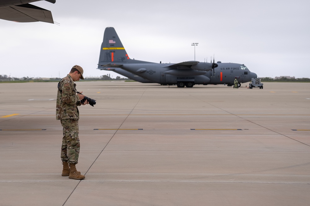 Public Affairs Specialist checks photos on the flightline at Channel Air National Guard Station, Calif.