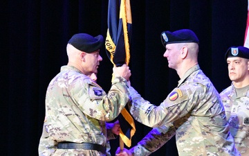 Command Sgt. Maj. Scott Beeson, the outgoing senior enlisted advisor for the U.S. Army Center for Initial Military Training, hands the unit colors one last time to Maj. Gen. John Kline during a Change of Responsibility ceremony at Fort Eustis April 12.