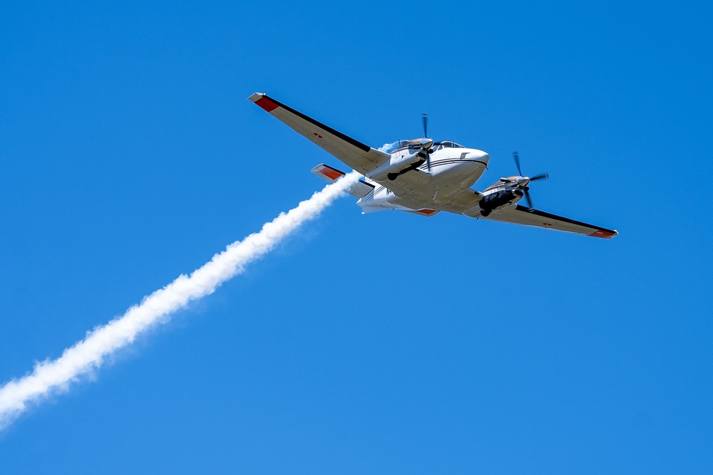 U.S. Forest Service Lead Plane dispenses a puff of smoke during Modular Airborne Fire Fighting System (MAFFS) Spring Training 2023 on April 14, 2023