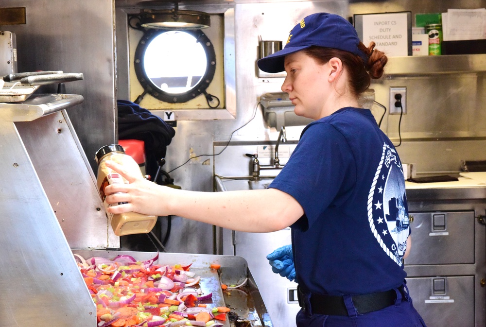 USCGC Eagle culinary specialists prepare cuisine while underway in the Atlantic Ocean