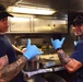 USCGC Eagle culinary specialists prepare cuisine while underway in the Atlantic Ocean