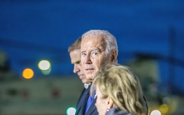U.S. President Joe Biden walks in front of a 1AD CAB CH-47 Chinook