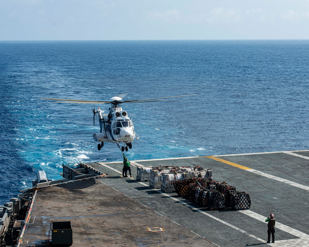 Sailors Secure Cargo To A Helicopter On Flight Deck