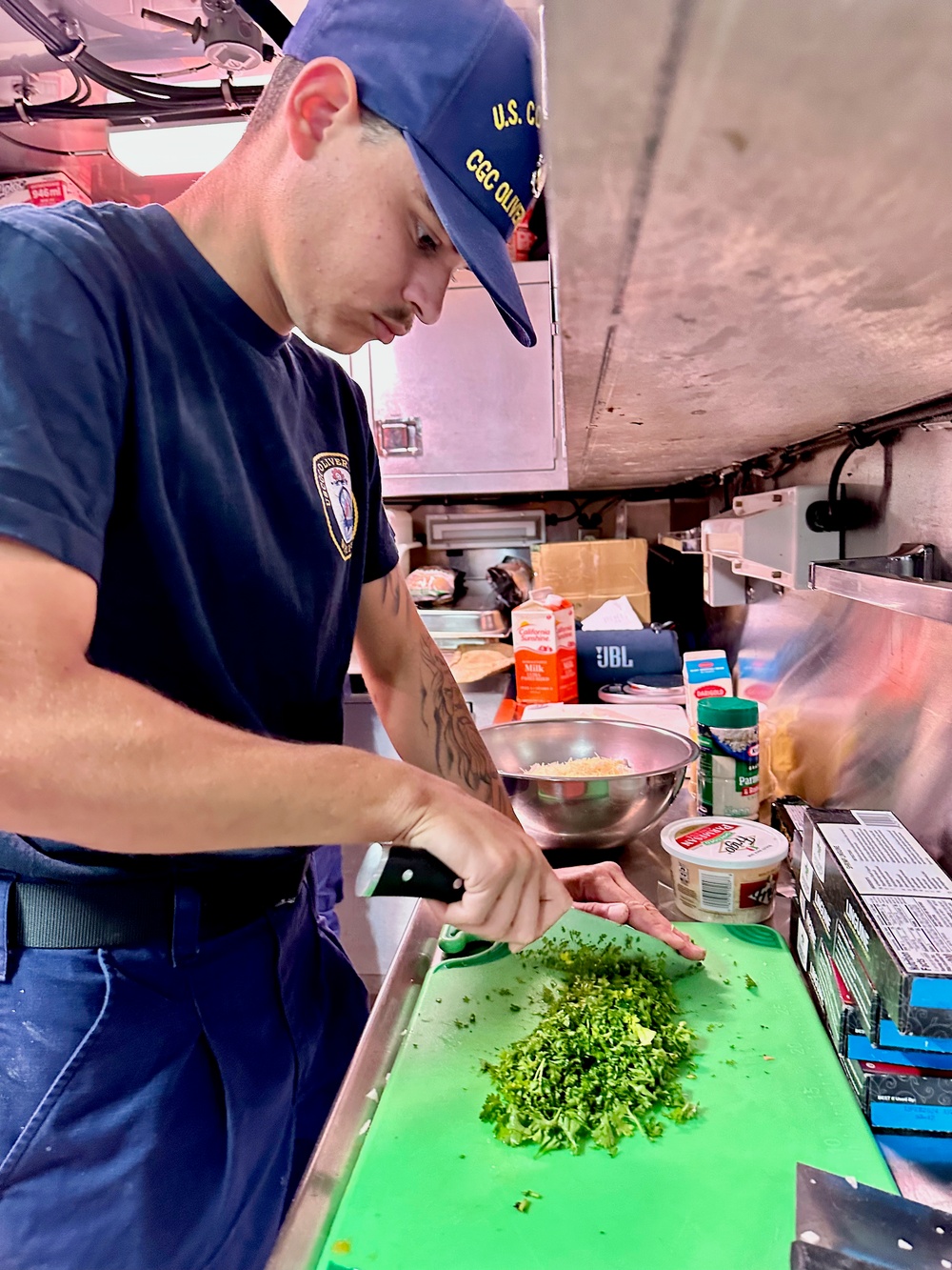 Culinary specialist prepares noon meal aboard USCGC Oliver Henry