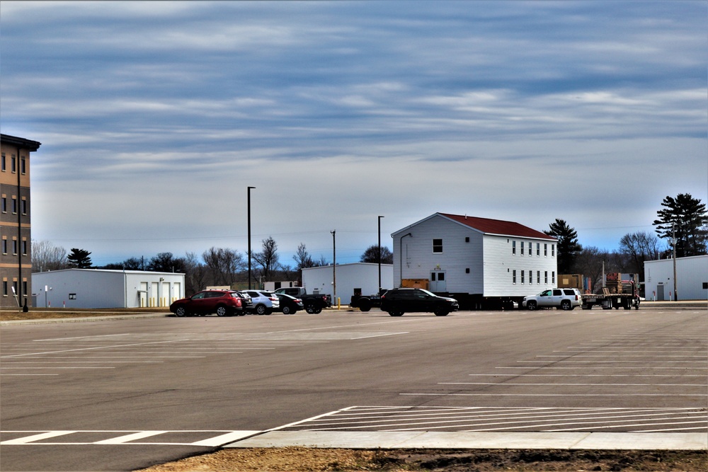 Contractors move third World War II-era barracks to new location