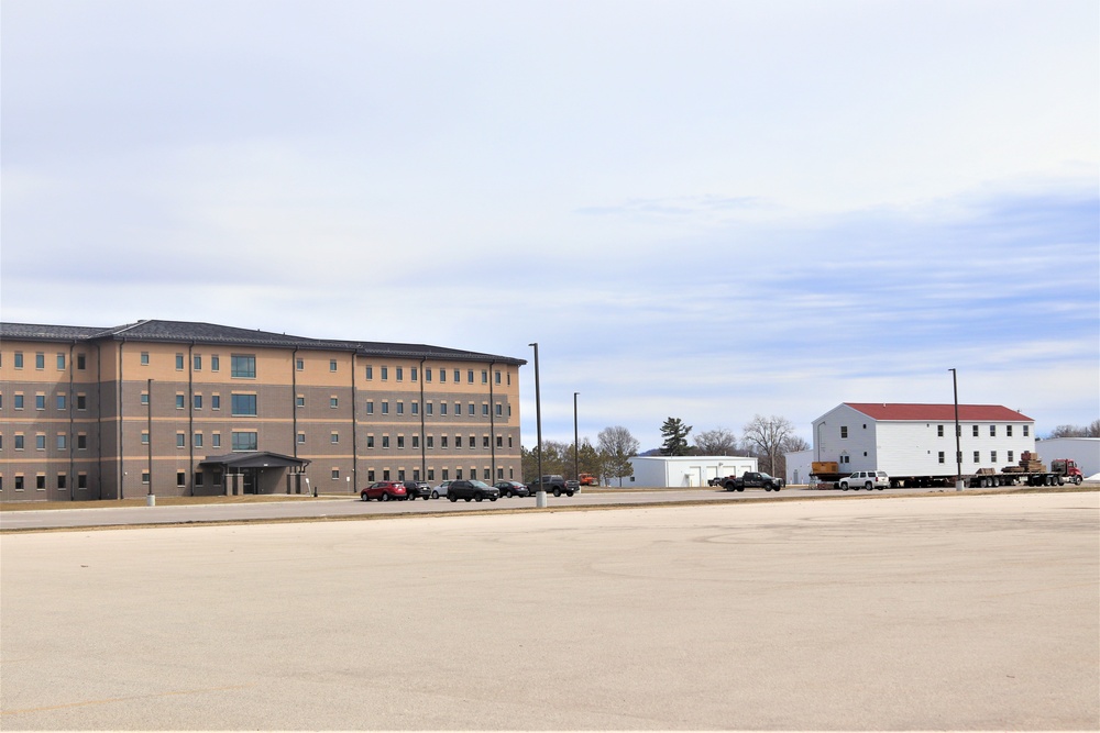 Contractors move third World War II-era barracks to new location