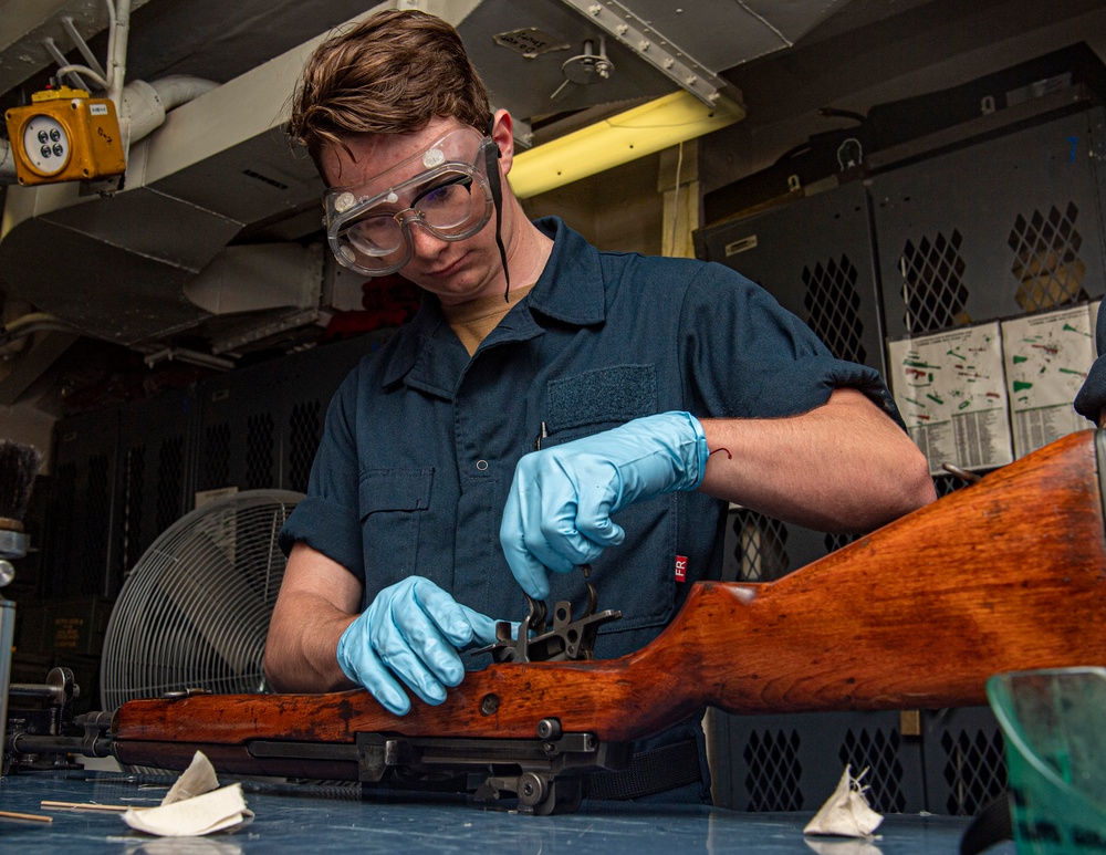 Sailor Performs Postfire Maintenance On Rifle