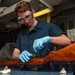 Sailor Performs Postfire Maintenance On Rifle