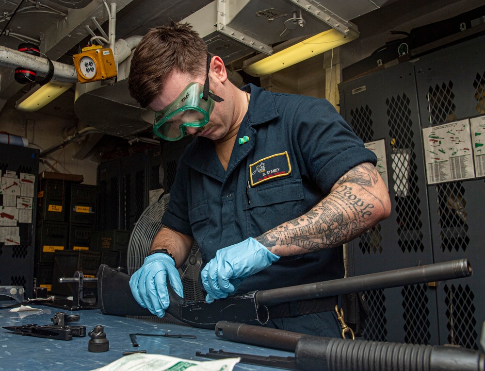 Sailor Performs Postfire Maintenance On Rifle