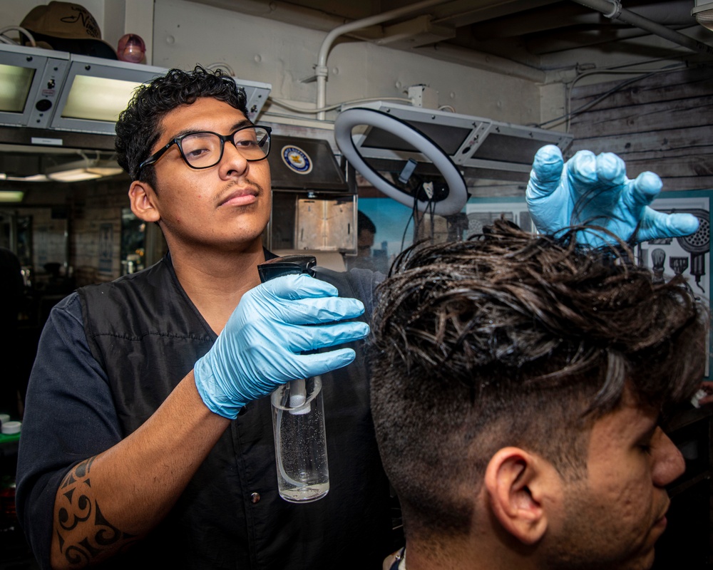 Sailor Wets A Customer's Hair During A Haircut