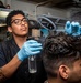 Sailor Wets A Customer's Hair During A Haircut