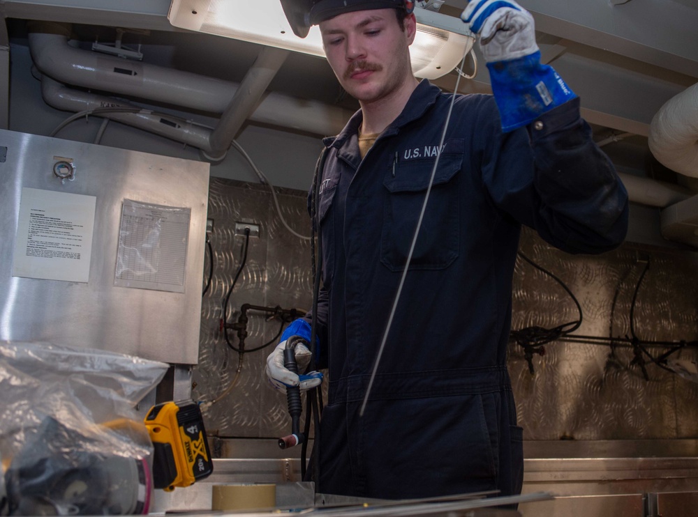 USS Ronald Reagan (CVN 76) Sailors weld metal countertop