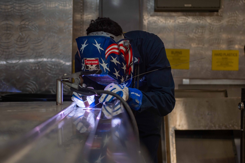 USS Ronald Reagan (CVN 76) Sailors weld metal countertop