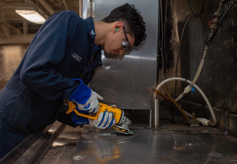 USS Ronald Reagan (CVN 76) Sailors weld metal countertop