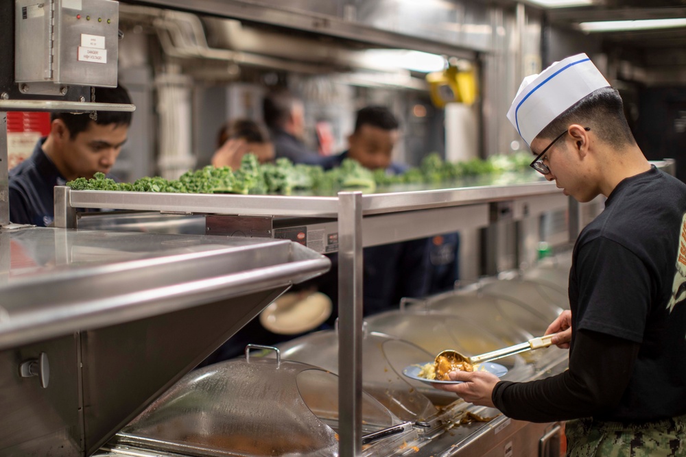 USS BATAAN Sailor serves lunch