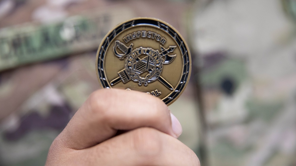 Soldier shows off coin from the Inspector General of the Army